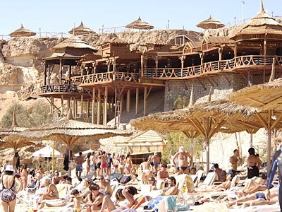 При пляже устроен большой навесной ресторан на деревянной террасе